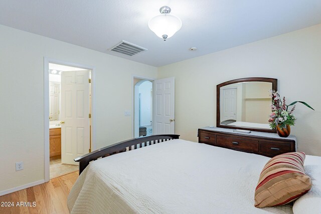 368 S 18th St, Coolidge, AZ 85128 - bedroom featuring visible vents, light wood-style flooring, arched walkways, and ensuite bath