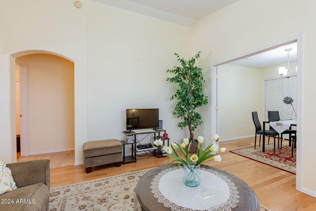 368 S 18th St, Coolidge, AZ 85128 - living room with baseboards, a notable chandelier, wood finished floors, and arched walkways