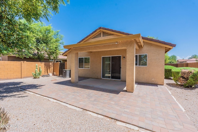 rear view of property featuring a patio and central air condition unit