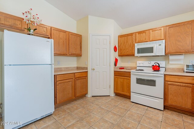 368 S 18th St, Coolidge, AZ 85128 - kitchen with light countertops, light tile patterned floors, brown cabinets, and white appliances