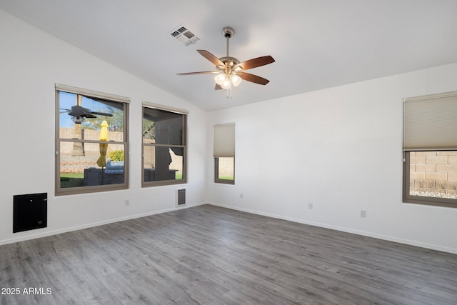 empty room with lofted ceiling, ceiling fan, and hardwood / wood-style flooring