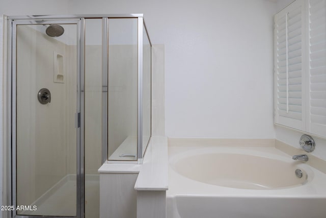 bathroom featuring separate shower and tub