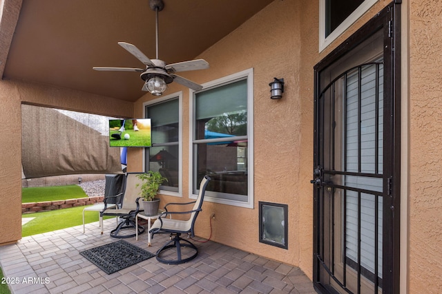 view of patio featuring ceiling fan