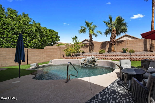 view of swimming pool with a patio area