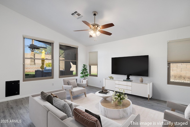 living room with ceiling fan, lofted ceiling, and wood-type flooring