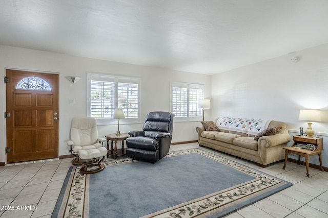 living area featuring light tile patterned flooring and baseboards