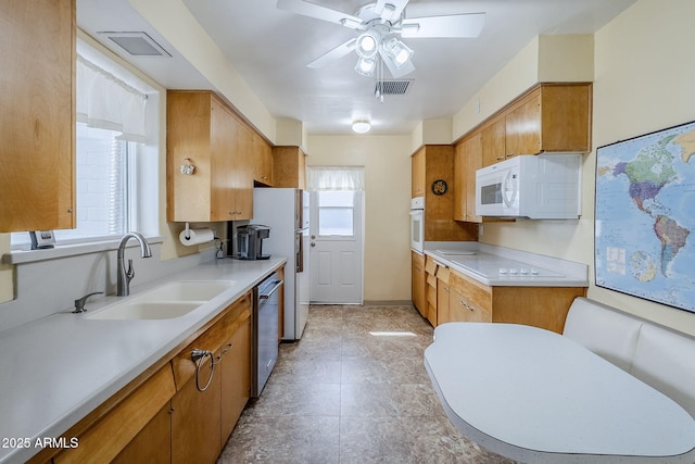 kitchen with white appliances, visible vents, light countertops, and a sink