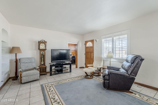 living room with light tile patterned floors and baseboards