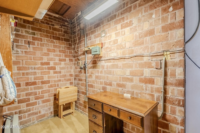 bathroom featuring brick wall