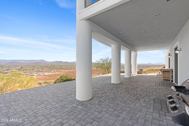 view of patio / terrace featuring a mountain view