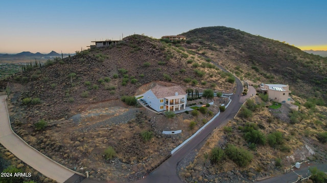 aerial view at dusk featuring a mountain view