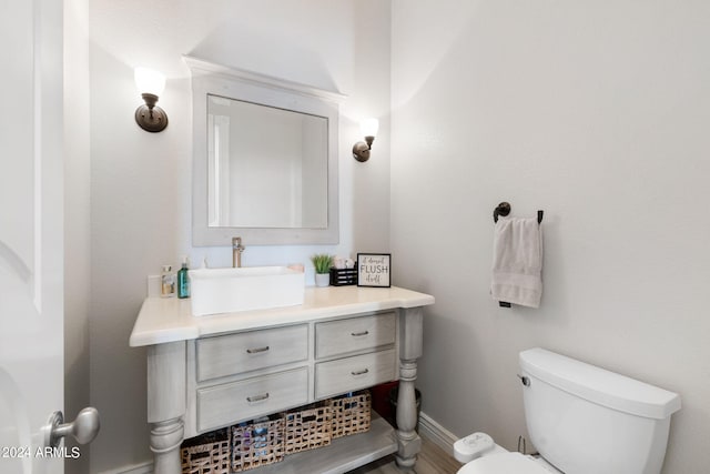 bathroom featuring hardwood / wood-style floors, vanity, and toilet