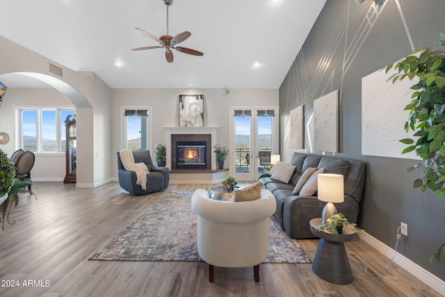 living room featuring hardwood / wood-style floors, a high end fireplace, and ceiling fan