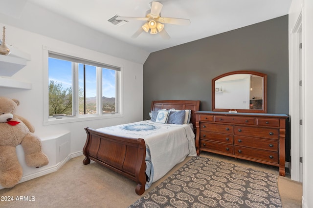 bedroom featuring lofted ceiling, ceiling fan, and light colored carpet