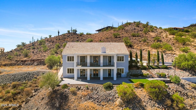 back of property with a patio and a balcony