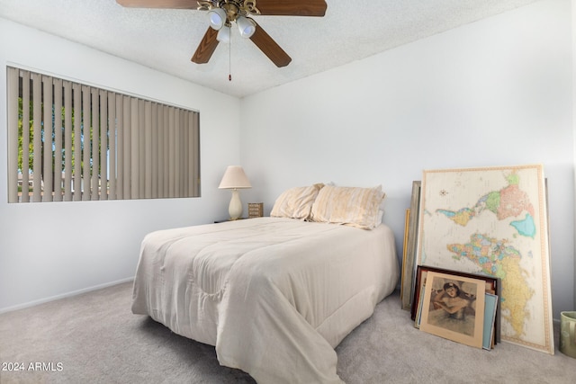 carpeted bedroom with a textured ceiling and ceiling fan