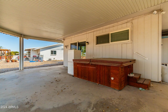 view of patio / terrace with a hot tub