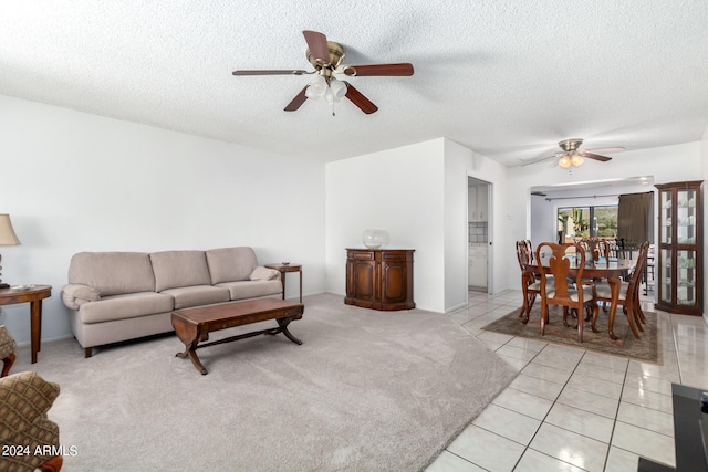 tiled living room featuring ceiling fan and a textured ceiling