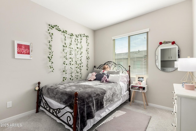 bedroom with light carpet and baseboards