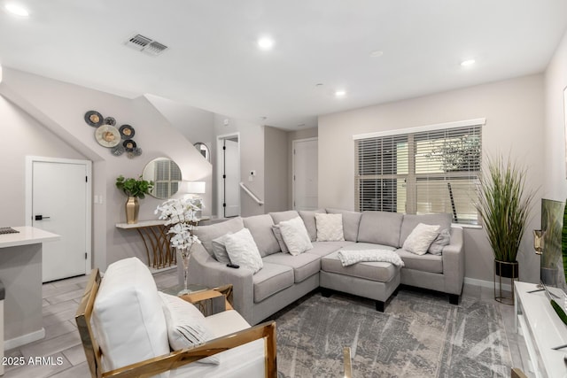 living area featuring baseboards, visible vents, and recessed lighting