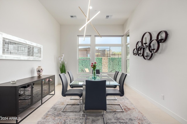 tiled dining space with a chandelier