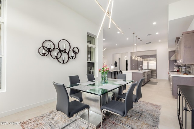 dining space with light tile patterned floors and sink