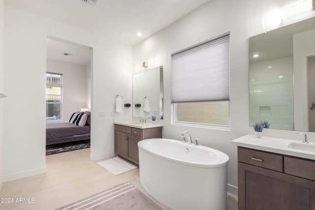 bathroom featuring vanity and a tub to relax in