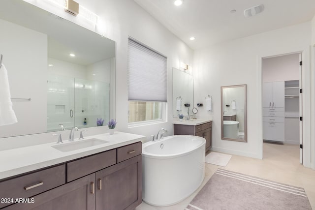 bathroom featuring tile patterned flooring, vanity, and shower with separate bathtub