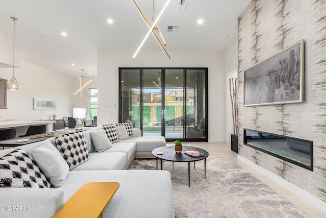 living room with a fireplace and an inviting chandelier