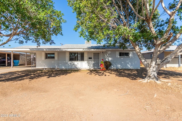 ranch-style home featuring a carport