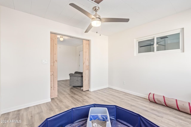 interior space featuring hardwood / wood-style floors and ceiling fan