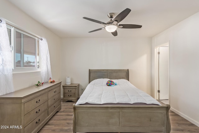 bedroom featuring ceiling fan and dark wood-type flooring