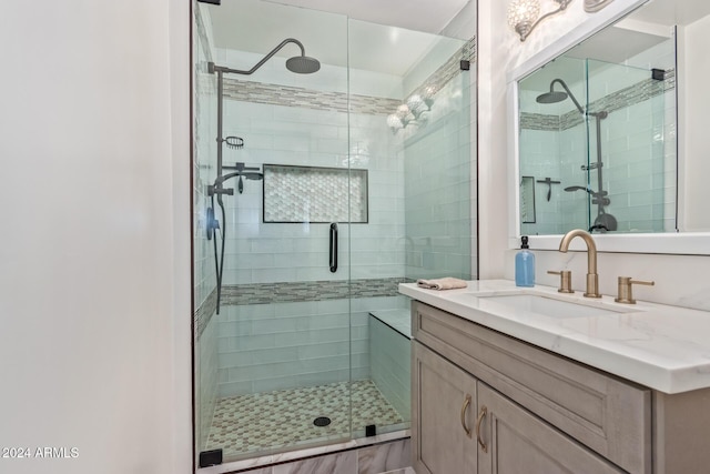 bathroom with vanity and a shower with door