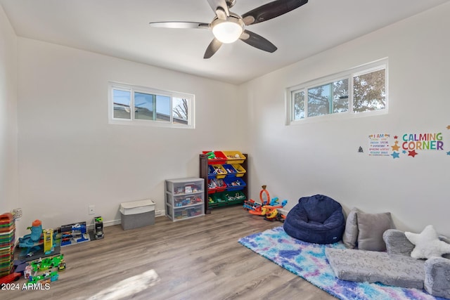 playroom with light wood-type flooring and ceiling fan