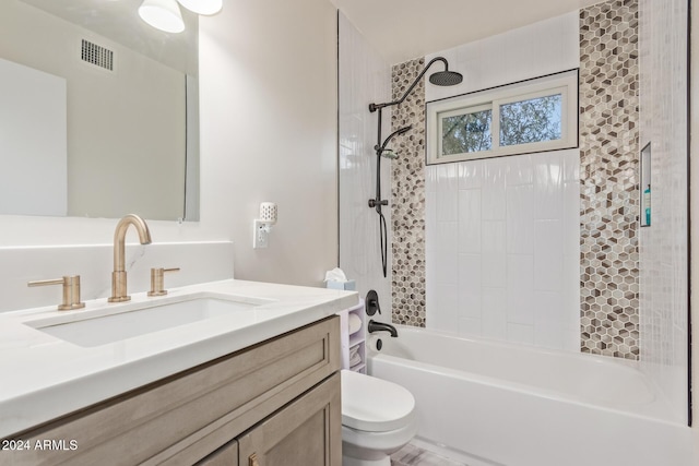 full bathroom with vanity, tiled shower / bath combo, and toilet