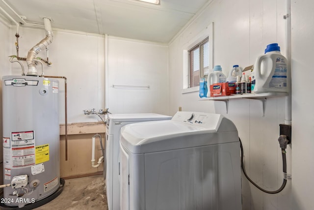 clothes washing area with water heater and washer and dryer