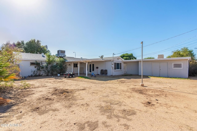 back of house featuring central AC