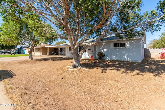 single story home featuring a carport