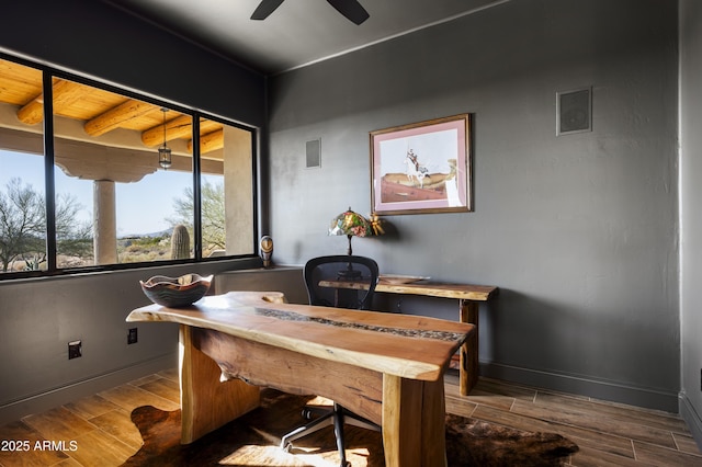 home office featuring visible vents, a ceiling fan, baseboards, and wood finish floors