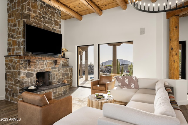 living area featuring wooden ceiling, wood finished floors, a chandelier, and beam ceiling