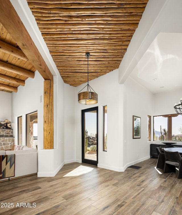 entryway with beamed ceiling, wood ceiling, baseboards, and wood finished floors