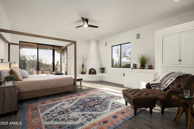 bedroom with visible vents, multiple windows, radiator, and baseboards