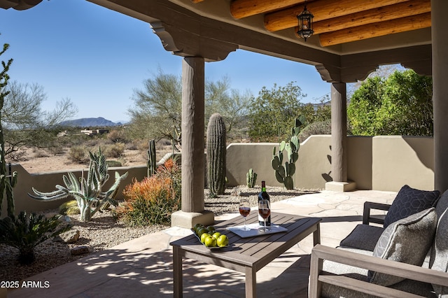 view of patio with fence and a mountain view