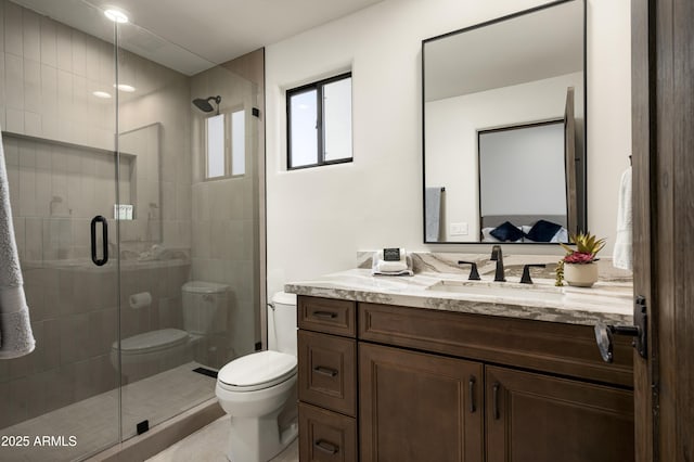 bathroom with vanity, toilet, and a shower stall