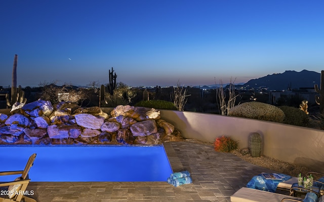 view of pool featuring a mountain view, a pool, and a patio area