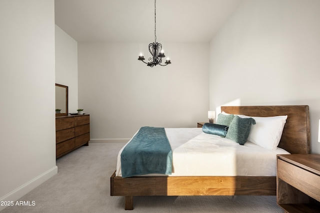 carpeted bedroom with a notable chandelier and baseboards