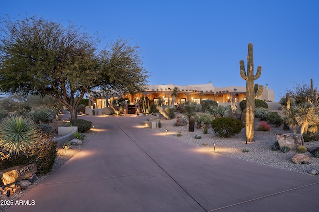 view of front of property with stucco siding and curved driveway