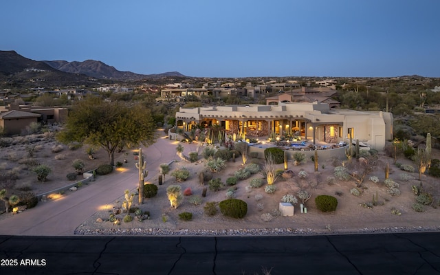 birds eye view of property with a mountain view