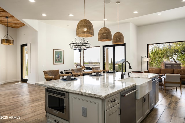 kitchen featuring dark wood finished floors, gray cabinets, recessed lighting, and open floor plan