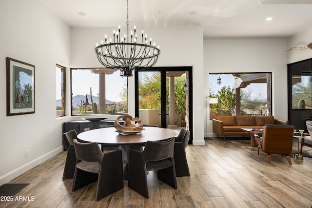 dining room with recessed lighting, baseboards, and light wood finished floors